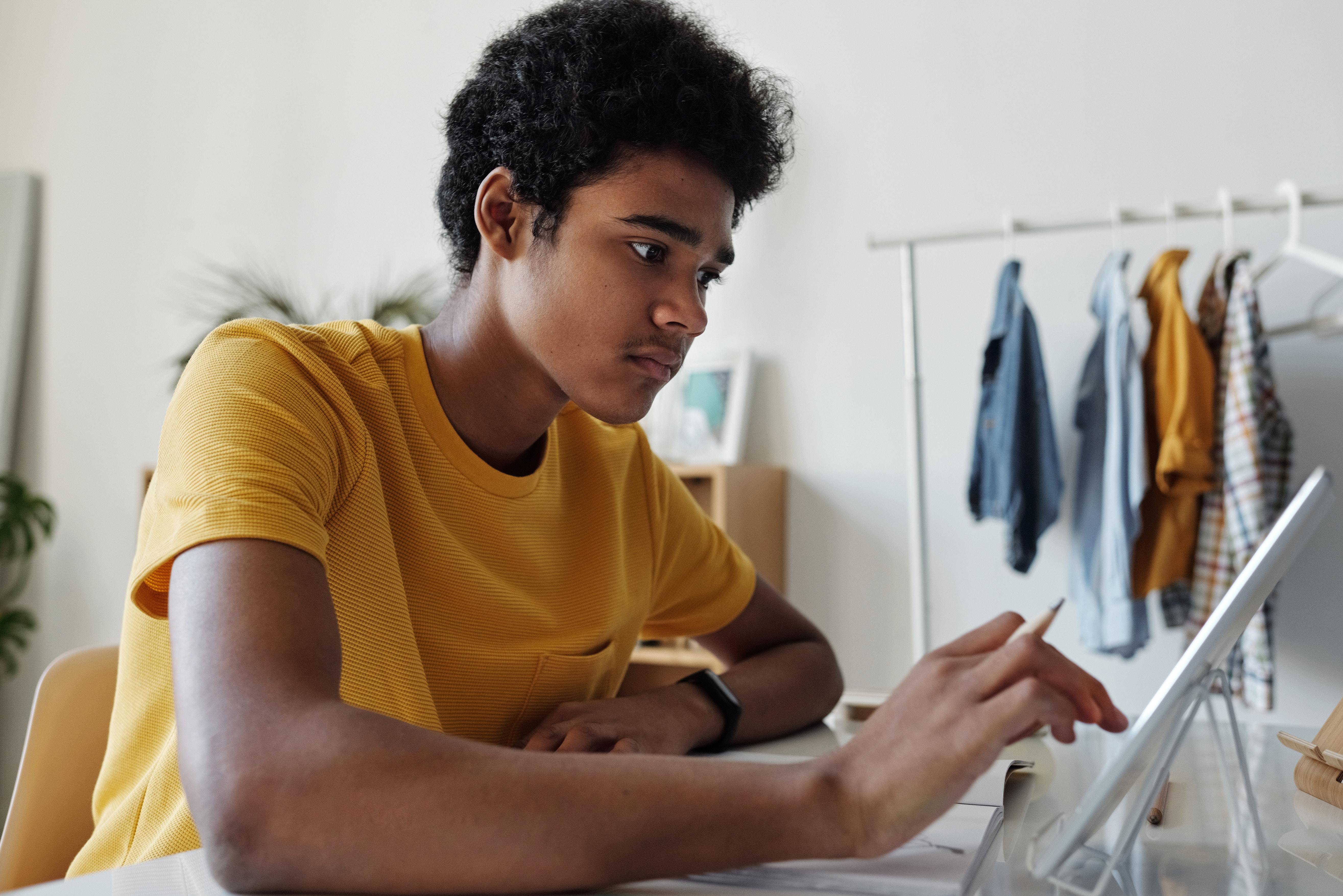 A black boy using a tablet